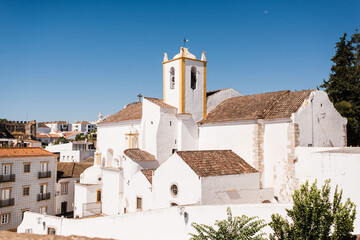 Fototapeta premium Views from the old castle of Tavira, southern Portugal, of the Santiago Church, a medieval church located in the old area. Very close to Santa Maria do Castelo.