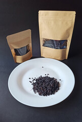 Dried elderberry berries in bag are ready for sale. Herbal medicine