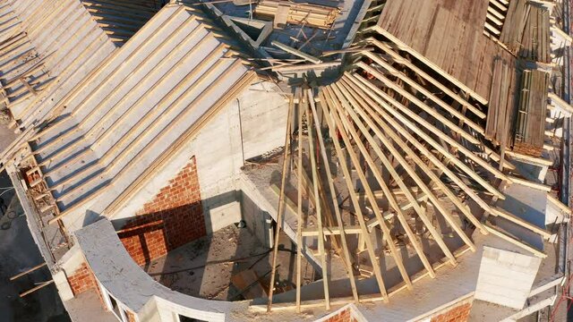 Roof construction of an apartment building. Timber formwork as a mold for concrete. Shuttering made of planks on the top floor and penthouse of a V-shaped corner house.