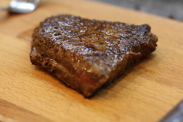 grilled steak on a wooden board