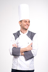 Pleased happy young chef posing isolated over white wall background in uniform.