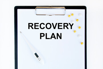 On the tablet for writing the text RECOVERY PLAN is applied, next to tablets and a thermometer.