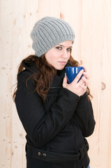 very warm woman in autumn or winter in a cabin