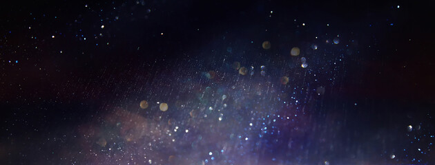 background of abstract glitter lights. Purple, silver, blue and black. de focused