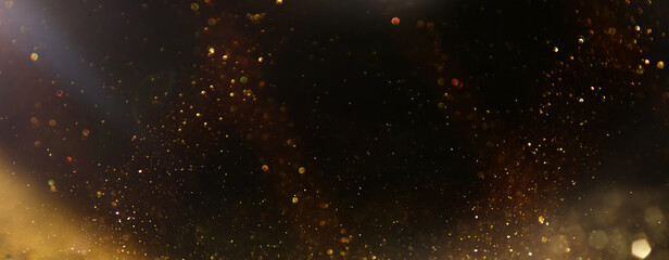 background of abstract glitter lights. silver, gold and black. de focused