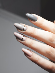 Closeup minimalist manicure design gray with stripes