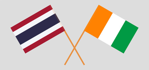 Crossed flags of Thailand and Republic of Ivory Coast