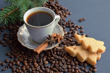 Fresh aromatic coffee and homemade cookies on a wooden background.