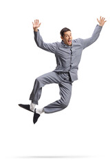 Young happy man in pajamas jumping