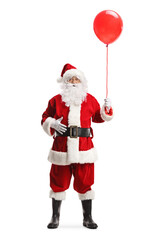 Full length portrait of santa claus holding a red balloon