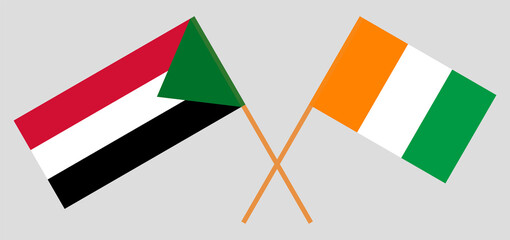 Crossed flags of Republic of Ivory Coast and Sudan