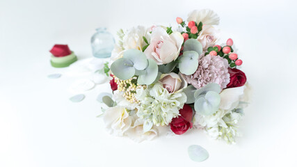 Obraz na płótnie Canvas An elegant bouquet of artificial flowers made of foamiran on a pale blue pastel background with copy space. Faux flowers made from plastic and foamiran. Valentine's day greeting card or invitation.
