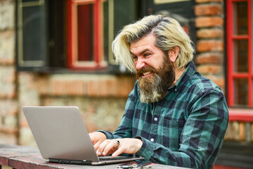 Online business. Online entrepreneur working outdoors. Man busy work with laptop. Businessman...