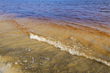 Small ocean waves splash near the coast of the Gulf of Mexico