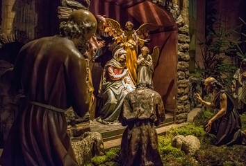 Traditional Christmas nativity scene with beautiful figures made out of wood. The birth of Jesus Christ in the manger surrounded by Joseph, Mary and shepherd.