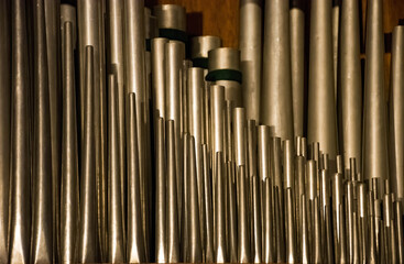A historic pipe organ inside a church. Old musical instrument, religious music.