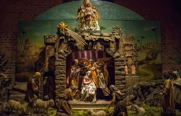 Traditional Christmas nativity scene with beautiful figures made out of wood. The birth of Jesus Christ in the manger surrounded by Joseph, Mary and shepherd.
