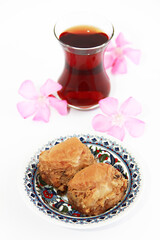 national Oriental Turkish baked sweet baklava in a decorative plate on a white background