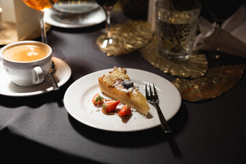 cheese cake on a plate and fork and strawberries 