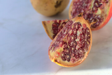 Juicy pomegranate cut into three pieces