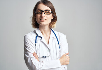 Portrait of a female doctor in a medical gown and a blue stethoscope