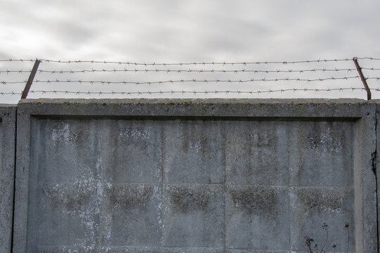 Old concrete fence with barbed wire.