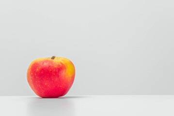 Isolated grapefruit with reflection on a table. Light background