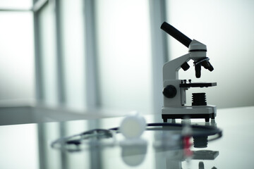 Stethoscope ampoule pill microscope on glass table