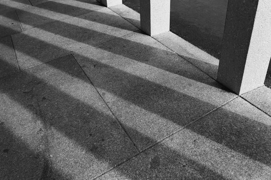 shadows of pilars on a pavement 