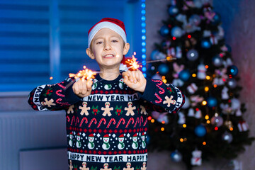 a boy with sparklers in his hands on a new year's background