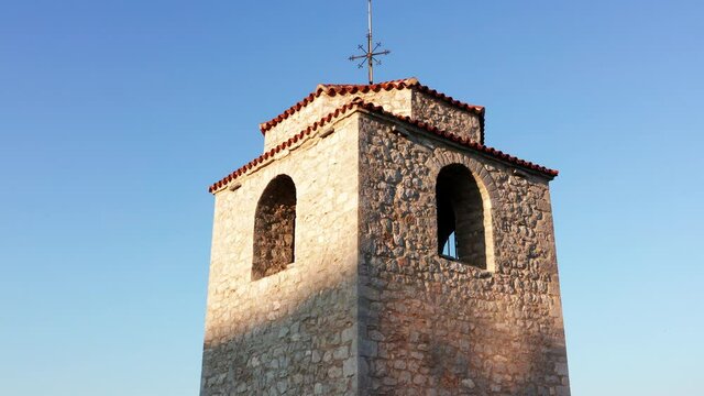 Old watchtower made of stone - tall medieval building with large holes near the top. Sahat kula in old town Podgorica Montenegro.