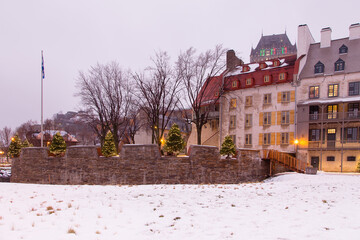 17th Century Royal Battery and historic buildings on Place de Paris covered in snow in the...