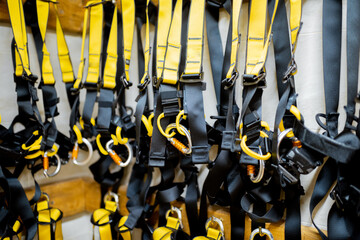Professional climbing equipment hanging at amusement park warehouse