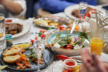 leftover festive table. banquet completion. half-eaten salads and snacks. alcohol and juices.