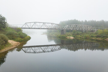 misty morning in the fog bridge over the river Gauja covered in the mist