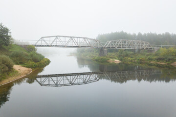 Fototapeta premium misty morning in the fog bridge over the river Gauja covered in the mist