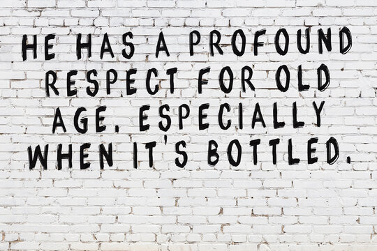 Painted black mindful inscription on white brick wall background