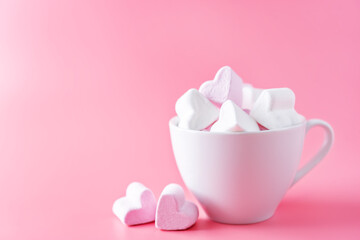 Pink background with cocoa cup with marshmallow for Valentine's day.