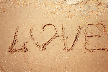 Handwritten Love Word on the Sand Coast. Wonderful words on beach sand. Love idea concept.