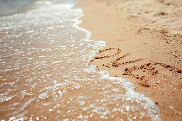Fototapeta na wymiar Handwritten Love Word on the Sand Coast. Wonderful words on beach sand. Love idea concept.