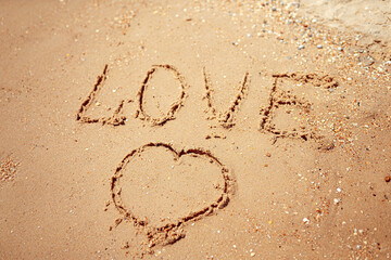 Handwritten Love Word on the Sand Coast. Wonderful words on beach sand. Love idea concept.