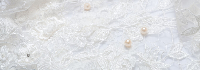 White luxurious guipure. Fabric for sewing a wedding dress. textile wedding background with beads. elegant wallpaper design