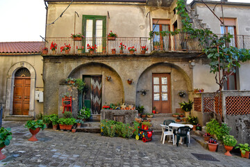 A narrow street among the old houses of San Severino Lucano, an old city in the Basilicata region, Italy.