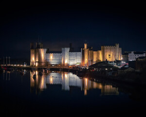 castle at night with water lights and reflection 