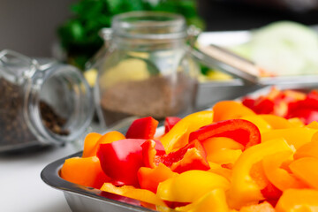 Chopped ingredients for making oriental vegetable stew. Paprika, potatoes, onions, tomatoes, garlic, peppers, spices.