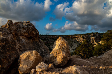 Sandy mountain road of the island of Cyprus in the light of the setting sun.