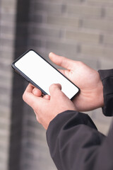 Man holding a cellphone with an empty screen. Screen mock up