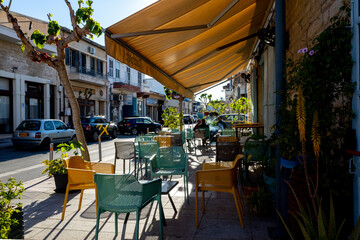 Naklejka premium April 22, 2019, Limassol, Cyprus. Tables in a summer cafe in the city on a bright Sunny day .