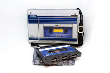 Old portable stereo audio tape cassette player isolated on a white background. Obsolete technology. 80s. Listening to music.