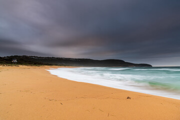 Low cloud filled sky and sunrise seascape